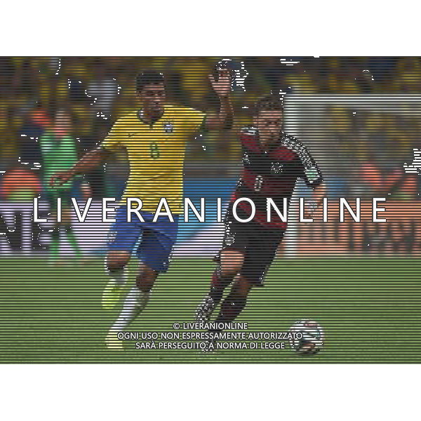 (140708) -- BELO HORIZONTE, July 8, 2014 () -- Brazil\'s Paulinho (L) vies with Germany\'s Mesut Ozil during a semifinal match between Brazil and Germany of 2014 FIFA World Cup at the Estadio Mineirao Stadium in Belo Horizonte, Brazil, on July 8, 2014. Germany won 7-1 over Brazil and qualified for the final on Tuesday. (/Li Ga)(pcy) ©photoshot/Agenzia Aldo Liverani sas - ITALY ONLY - EDITORIAL USE ONLY - BRASILE VS GERMANIA partita di semifinale Coppa del mondo FIFA 2014 Mineirao stadio Estadio a Belo Horizonte, in Brasile, 8 luglio 2014, la Germania ha vinto 7-1 e qualificato per la finale