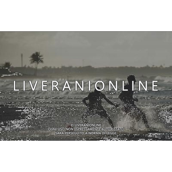 (140710) -- SALVADOR, July 10, 2014 () -- Two men vie for a football in the early morning on a beach in Salvador, Brazil, on July 6, 2014. (/Yang Lei) ©PHOTOSHOT/Agenzia Aldo Liverani sas - - ITALY ONLY - EDITORIAL USE ONLY - La popolazione locale si gode la spiaggia e il mare a Salvador, in Brasile, 3 luglio 2014