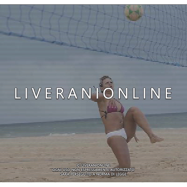 (140710) -- SALVADOR, July 10, 2014 () -- A woman plays foot volleyball in the early morning on a beach in Salvador, Brazil, on July 5, 2014. (/Yang Lei) ©PHOTOSHOT/Agenzia Aldo Liverani sas - - ITALY ONLY - EDITORIAL USE ONLY - La popolazione locale si gode la spiaggia e il mare a Salvador, in Brasile, 3 luglio 2014