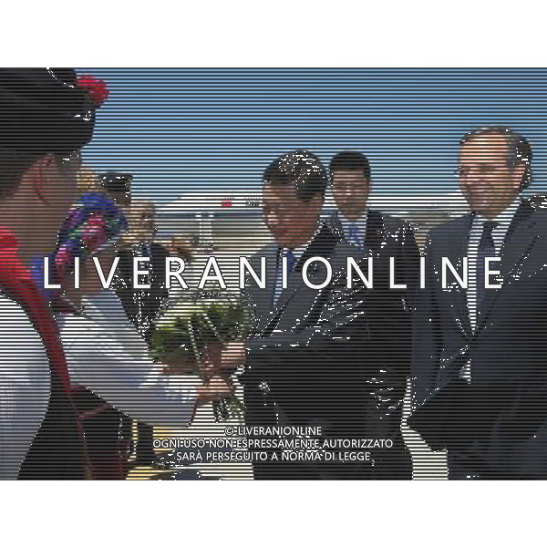 (140713) -- RHODES ISLAND, July 13, 2014 () -- Chinese President Xi Jinping (C), who is accompanied by Greek Prime Minister Antonis Samaras (1st R), receives a bouquet presented by local youths after arriving at the Diagoras International Airport on the Rhodes Island in Greece, July 13, 2014. Xi Jinping arrived in Greece on Sunday to make a stopover on his way to Latin America, where he will pay state visits to Brazil, Argentina, Venezuela and Cuba, as well as attend the sixth BRICS Summit. (/Lan Hongguang) (lmm) ©PHOTOSHOT/Agenzia Aldo Liverani sas - ITALY ONLY - EDITORIAL USE ONLY