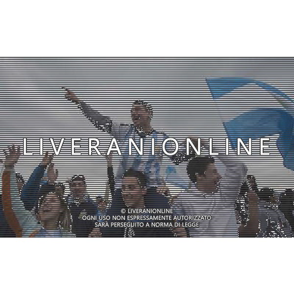 (140715) -- EZEIZA, July 15, 2014 () -- Argentinian fans rally to welcome their national football team upon their arrival, in Ezeiza city, Argentina, on July 14, 2014. Argentina National Team returned after won the silver in the 2014 FIFA World Cup Brazil. (/Martin Zabala) (da) (sp) ©PHOTOSHOT/Agenzia Aldo Liverani sas - ITALY ONLY - EDITORIAL USE ONLY - I tifosi accolgono la quadra nazionale di calcio dell\'argentina al loro arrivo, nei pressi della Federcalcio), nella citta\' di Ezeiza, 14 luglio 2014 dopo aver vinto l\'argento alla coppa del mondo FIFA 2014 in Brasile