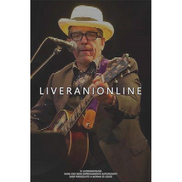 English singer-songwriter Elvis Costello performs at Kew Gardens, Richmond, Greater London, England, UK on Wednesday 16th July 2014 as part of the Kew The Music Series of concerts. Costello lived locally in Twickenham and the gig is billed as a homecoming gig. ©PHOTOSHOT/Agenzia Aldo Liverani sas - ITALY ONLY - EDITORIAL USE ONLY