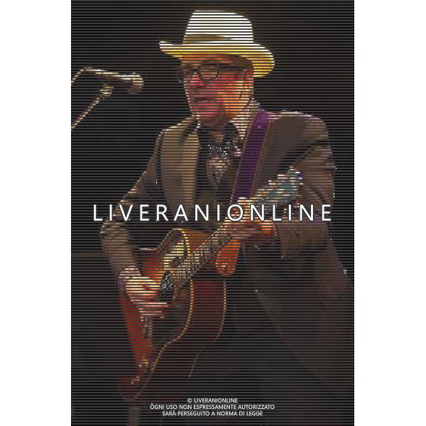 English singer-songwriter Elvis Costello performs at Kew Gardens, Richmond, Greater London, England, UK on Wednesday 16th July 2014 as part of the Kew The Music Series of concerts. Costello lived locally in Twickenham and the gig is billed as a homecoming gig. ©PHOTOSHOT/Agenzia Aldo Liverani sas - ITALY ONLY - EDITORIAL USE ONLY