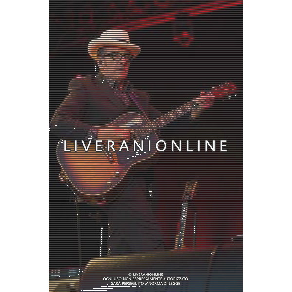English singer-songwriter Elvis Costello performs at Kew Gardens, Richmond, Greater London, England, UK on Wednesday 16th July 2014 as part of the Kew The Music Series of concerts. Costello lived locally in Twickenham and the gig is billed as a homecoming gig. ©PHOTOSHOT/Agenzia Aldo Liverani sas - ITALY ONLY - EDITORIAL USE ONLY
