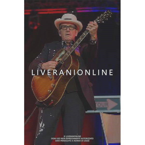 English singer-songwriter Elvis Costello performs at Kew Gardens, Richmond, Greater London, England, UK on Wednesday 16th July 2014 as part of the Kew The Music Series of concerts. Costello lived locally in Twickenham and the gig is billed as a homecoming gig. ©PHOTOSHOT/Agenzia Aldo Liverani sas - ITALY ONLY - EDITORIAL USE ONLY