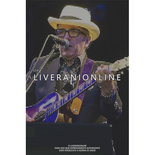 English singer-songwriter Elvis Costello performs at Kew Gardens, Richmond, Greater London, England, UK on Wednesday 16th July 2014 as part of the Kew The Music Series of concerts. Costello lived locally in Twickenham and the gig is billed as a homecoming gig. ©PHOTOSHOT/Agenzia Aldo Liverani sas - ITALY ONLY - EDITORIAL USE ONLY