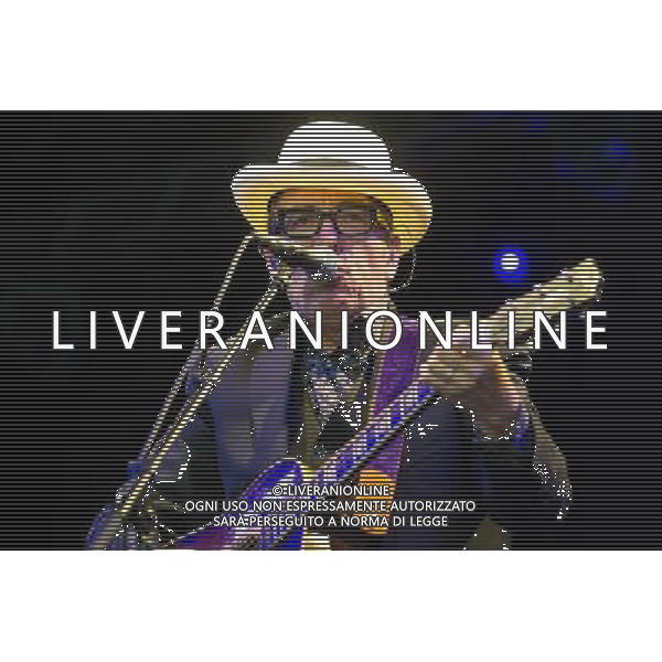 English singer-songwriter Elvis Costello performs at Kew Gardens, Richmond, Greater London, England, UK on Wednesday 16th July 2014 as part of the Kew The Music Series of concerts. Costello lived locally in Twickenham and the gig is billed as a homecoming gig. ©PHOTOSHOT/Agenzia Aldo Liverani sas - ITALY ONLY - EDITORIAL USE ONLY