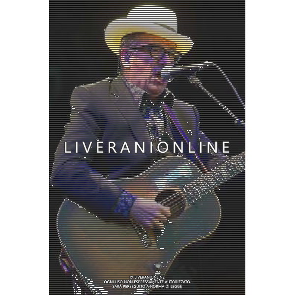 English singer-songwriter Elvis Costello performs at Kew Gardens, Richmond, Greater London, England, UK on Wednesday 16th July 2014 as part of the Kew The Music Series of concerts. Costello lived locally in Twickenham and the gig is billed as a homecoming gig. ©PHOTOSHOT/Agenzia Aldo Liverani sas - ITALY ONLY - EDITORIAL USE ONLY