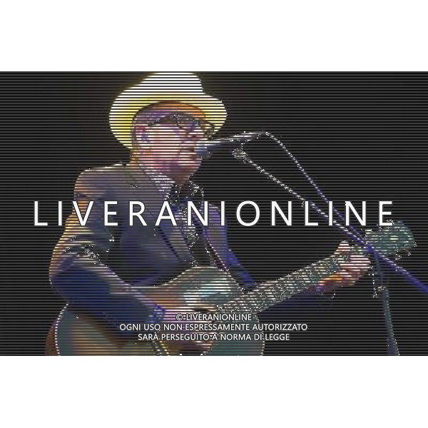 English singer-songwriter Elvis Costello performs at Kew Gardens, Richmond, Greater London, England, UK on Wednesday 16th July 2014 as part of the Kew The Music Series of concerts. Costello lived locally in Twickenham and the gig is billed as a homecoming gig. ©PHOTOSHOT/Agenzia Aldo Liverani sas - ITALY ONLY - EDITORIAL USE ONLY