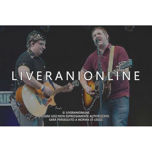 The MacManus Brothers (Ronan MacManus - maroon shirt and Ruairi MacManus - black shirt), brothers of Elvis Costello, perform at Kew Gardens, Richmond, Greater London, England, UK on Wednesday 16th July 2014 as part of the Kew The Music Series of concerts. ©PHOTOSHOT/Agenzia Aldo Liverani sas - ITALY ONLY - EDITORIAL USE ONLY