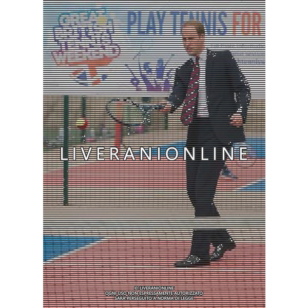 COVENTRY, ENGLAND - JULY 16: Prince William, Duke of Cambridge plays tennis during an official visit to the Coventry War Memorial Park on July 16, 2014 in Coventry, England. The Duke made the visit to mark the Centenary of the First World War. () ©photoshot/Agenzia Aldo Liverani sas - ITALY ONLY - EDITORIAL USE ONLY - REALI INGLESI: Il Principe William, in visita al War Memorial Park, Coventry, il Parco dedicato al sacrificio di coloro che hanno perso la vita nella Grande Guerra, inghilterra 17 luglio 2014