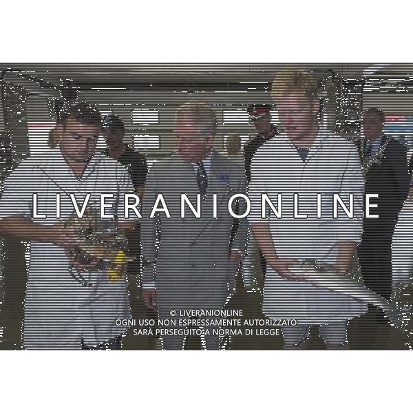 The Duke of Cornwall, President, Prince\'s Trust, and The Duchess of Cornwall toured Looe, where they met FISH MARKET PORTERS SAM CHAPMAN WITH A LARGE LOBSTER, AND SEAN COOMBER WITH THE SEA BREAM HELPED BY THE PRINCES TRUST . Picture: ©photoshot/Agenzia Aldo Liverani sas - ITALY ONLY - EDITORIAL USE ONLY - REALI INGLESI: Il Principe Carlo d\'inghilterra con la moglie Camilla duchessa di Cornovaglia, ha visitato il mercato di via Looe