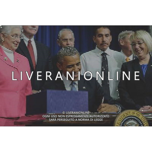 (140722)--WASHINGTON D.C., July 22, 2014 ()--U.S. President Barack Obama (C) signs the Workforce Innovation and Opportunity Act at White House in Washington D.C., capital of the United States, July 22, 2014. U.S. President Barack Obama singed H.R.803, the Workforce Innovation and Opportunity Act, which reauthorizes and reforms core workforce development programs administered by the Departments of Education and Labor and transfers from the Department of Education to the Department of Health and Human Services certain disability and independent living program functions, on Tuesday. (/Bao Dandan) ©PHOTOSHOT/AGENZIA ALDO LIVERANI SAS - ITALY ONLY - EDITORIAL USE ONLY