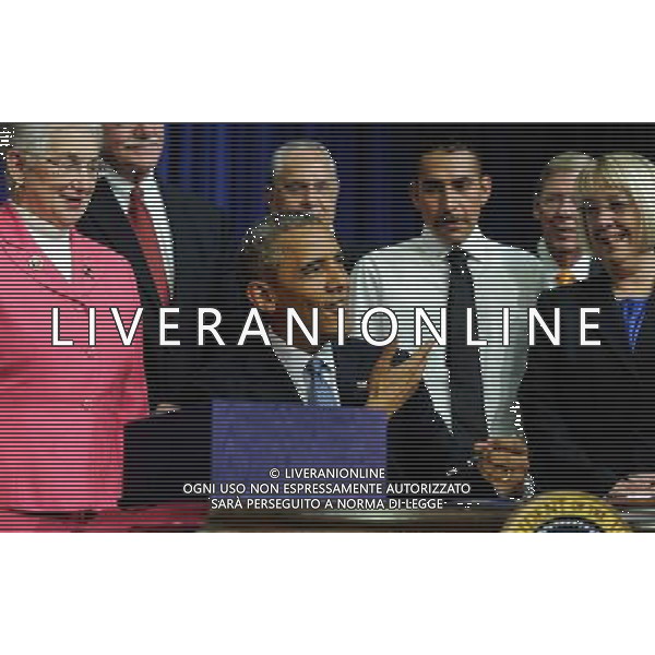 (140722)--WASHINGTON D.C., July 22, 2014 ()--U.S. President Barack Obama (C) signs the Workforce Innovation and Opportunity Act at White House in Washington D.C., capital of the United States, July 22, 2014. U.S. President Barack Obama singed H.R.803, the Workforce Innovation and Opportunity Act, which reauthorizes and reforms core workforce development programs administered by the Departments of Education and Labor and transfers from the Department of Education to the Department of Health and Human Services certain disability and independent living program functions, on Tuesday. (/Bao Dandan) ©PHOTOSHOT/AGENZIA ALDO LIVERANI SAS - ITALY ONLY - EDITORIAL USE ONLY