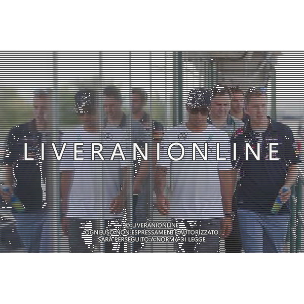 (140726) -- MOGYOROD, July 26, 2014 () -- Mercedes Formula One driver Lewis Hamilton (L) of Britain and Red Bull driver Sebastian Vettel (R) of Germany walk to a drivers\' briefing during the F1 Hungarian Grand Prix at Hungaroring in Mogyorod, Hungary on July 25, 2014. Lewis Hamilton set the fastest time with 1 minute 25.814 seconds in the first free practice session. He also set the fastest time with 1 minute 24.482 seconds in the second free practice session. (/Attila Volgyi) ©photoshot/AGENZIA ALDO LIVERANI SAS - ITALY ONLY - EDITORIAL USE ONLY