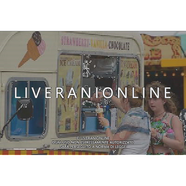 Atmosphere at WOMAD - World of Music, Arts and Dance. Purchasing Ice-Cream from a period Ice-Cream van. ©PHOTOSHOT/Agenzia Aldo Liverani sas - ITALY ONLY - EDITORIAL USE ONLY