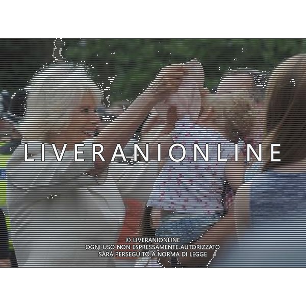 (h) Camilla Duchess of Cornwall picks up a hat dropped by a child and attempts to place it back on the reluctant child\'s head during a visit to the market town of Oakham Prince of Wales and Duchess of Cornwall visits Rutland, Britain - 28 Jul 2014 ©photoshot/Agenzia Aldo Liverani sas - ITALY ONLY - EDITORIAL USE ONLY - REALI INGLESI: Il Principe Carlo d\'inghilterra e la moglie Camilla Duchessa di Cornovaglia in visita ufficiale alla citta\' mercato di Oakham Rutland, Regno Unito - 28 luglio 2014