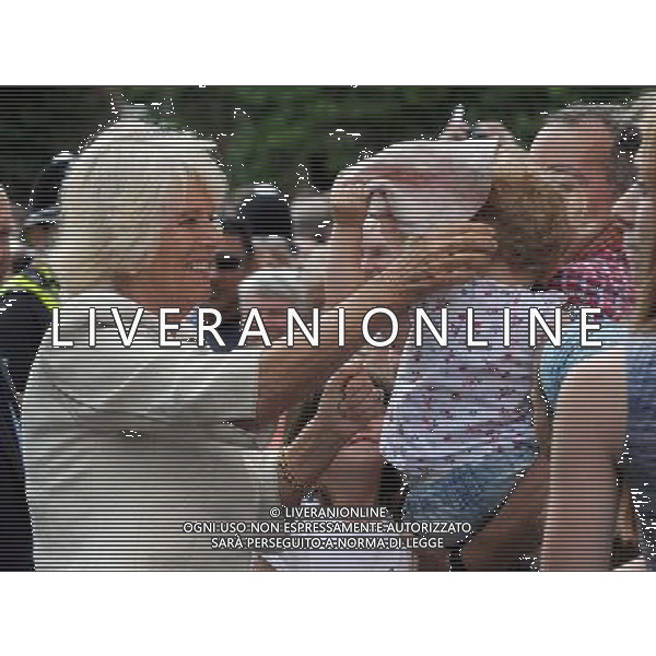 (i) Camilla Duchess of Cornwall picks up a hat dropped by a child and attempts to place it back on the reluctant child\'s head during a visit to the market town of Oakham Prince of Wales and Duchess of Cornwall visits Rutland, Britain - 28 Jul 2014 ©photoshot/Agenzia Aldo Liverani sas - ITALY ONLY - EDITORIAL USE ONLY - REALI INGLESI: Il Principe Carlo d\'inghilterra e la moglie Camilla Duchessa di Cornovaglia in visita ufficiale alla citta\' mercato di Oakham Rutland, Regno Unito - 28 luglio 2014