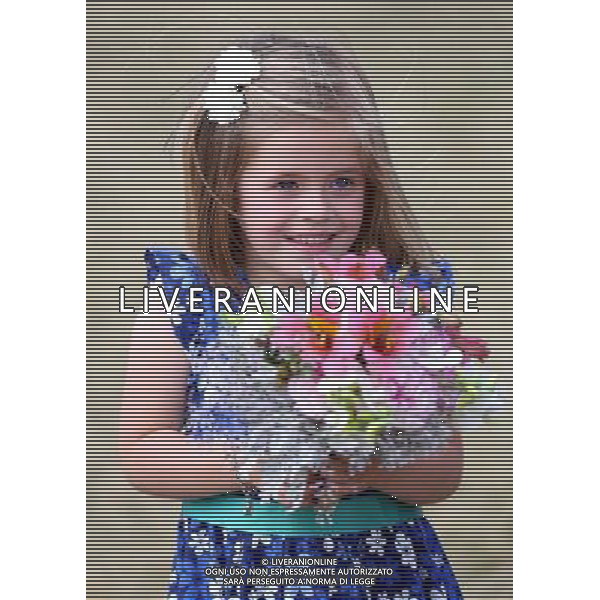 Five year old Hollie Ford who presented the Duchess of Cornwall with a posy on her arrival at the Sandringham flower show held on the Royal Estate in Norfolk. ©photoshot/Agenzia Aldo Liverani sas - ITALY ONLY - REALI INGLESI: Camilla Duchessa di Cornovaglia durante la sua visita alla mostra floreale Sandringham tenutasi sul Royal Estate a Norfolk.