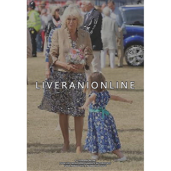 Five year old Hollie Ford present the Duchess of Cornwall with a posy on her arrival at the Sandringham flower show held on the Royal Estate in Norfolk. ©photoshot/Agenzia Aldo Liverani sas - ITALY ONLY - REALI INGLESI: Camilla Duchessa di Cornovaglia durante la sua visita alla mostra floreale Sandringham tenutasi sul Royal Estate a Norfolk.