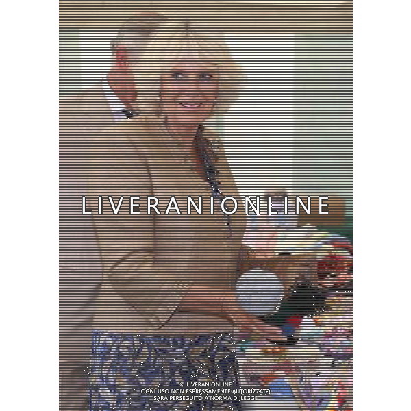 The Duchess of Cornwall buys a chimney sweep knitted doll for her grandson, Prince George, at the Women\'s Institute stand during her visit to the Sandringham flower show held on the Royal Estate in Norfolk. ©photoshot/Agenzia Aldo Liverani sas - ITALY ONLY - REALI INGLESI: Camilla Duchessa di Cornovaglia durante la sua visita alla mostra floreale Sandringham tenutasi sul Royal Estate a Norfolk.