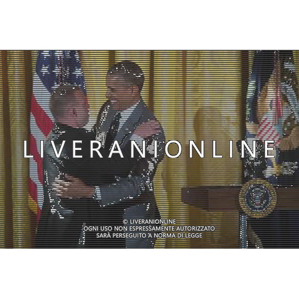 United States President Barack Obama, right, embraces restaurateur Tim Johnson after Obama mentioned him while speaking at an event titled \'A Celebration of Special Olympics and A Unified Generation\' to mark the anniversary of the Special Olympics in the East Room of the White House in Washington, D.C., U.S., on Thursday, July 31, 2014. Founded in 1968 by Mrs Kennedy Shriver, the Special Olympics movement has grown to more than 4.4 million athletes in 170 countries. ©PHOTOSHOT/Agenzia Aldo Liverani sas - ITALY ONLY - EDITORIAL USE ONLY - Il presidente americano Barack Obama al concerto per commemorare le Special Olympics nella Dining Room della Casa Bianca a Washington, DC, Stati Uniti, 31 luglio 2014