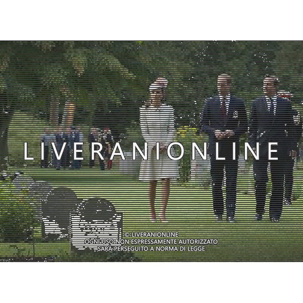 MONS, BELGIUM - AUGUST 04: Catherine, Duchess of Cambridge, Prince William, Duke of Cambridge and Prime Minister David Cameron walk through war graves at St Symphorien Military Cemetery on August 4, 2014 in Mons, Belgium. Monday 4th August marks the 100th Anniversary of Great Britain declaring war on Germany. In 1914 British Prime Minister Herbert Asquith announced at 11pm that Britain was to enter the war after Germany had violated Belgium\'s neutrality. The First World War or the Great War lasted until 11 November 1918 and is recognised as one of the deadliest historical conflicts with millions of casualties. A series of events commemorating the 100th Anniversary are taking place throughout the day. ©PHOTOSHOT/Agenzia Aldo Liverani sas - ITALY ONLY - EDITORIAL USE ONLY - REALI INGLESI: Il principe William d\'Inghilterra e la moglie Kate Duchessa di Cambridge e il principe Harry al St Symphorien cimitero militare a Mons, Belgio 4 agosto 2014 nel 100mo Anniversario della Grande guerra