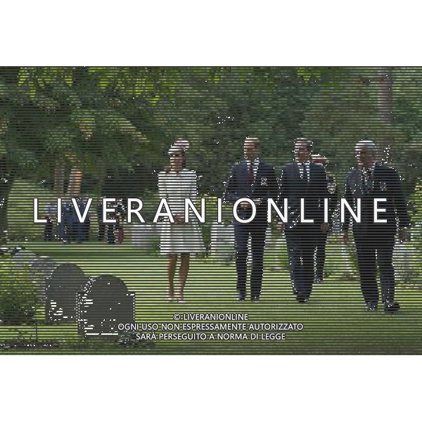 MONS, BELGIUM - AUGUST 04: Catherine, Duchess of Cambridge , Prince William, Duke of Cambridge and Prime Minister David Cameron walk through war graves at St Symphorien Military Cemetery on August 4, 2014 in Mons, Belgium. Monday 4th August marks the 100th Anniversary of Great Britain declaring war on Germany. In 1914 British Prime Minister Herbert Asquith announced at 11pm that Britain was to enter the war after Germany had violated Belgium\'s neutrality. The First World War or the Great War lasted until 11 November 1918 and is recognised as one of the deadliest historical conflicts with millions of casualties. A series of events commemorating the 100th Anniversary are taking place throughout the day. ©PHOTOSHOT/Agenzia Aldo Liverani sas - ITALY ONLY - EDITORIAL USE ONLY - REALI INGLESI: Il principe William d\'Inghilterra e la moglie Kate Duchessa di Cambridge e il principe Harry al St Symphorien cimitero militare a Mons, Belgio 4 agosto 2014 nel 100mo Anniversario della Grande guerra
