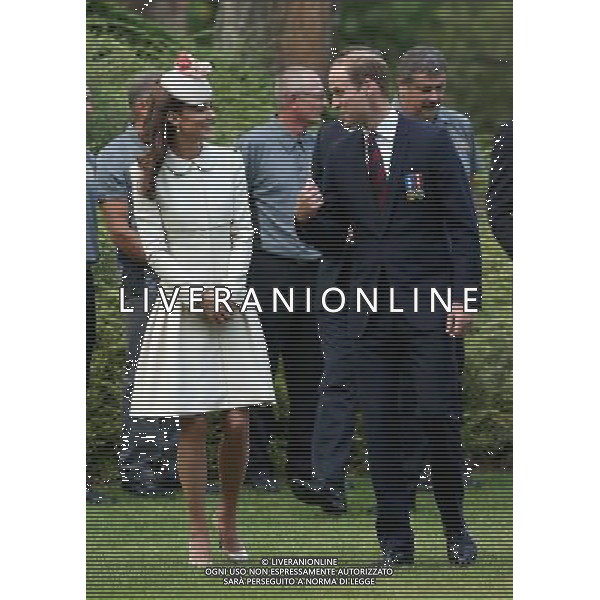 MONS, BELGIUM - AUGUST 04: Catherine, Duchess of Cambridge and Prince William, Duke of Cambridge walk through war graves at St Symphorien Military Cemetery on August 4, 2014 in Mons, Belgium. Monday 4th August marks the 100th Anniversary of Great Britain declaring war on Germany. In 1914 British Prime Minister Herbert Asquith announced at 11pm that Britain was to enter the war after Germany had violated Belgium\'s neutrality. The First World War or the Great War lasted until 11 November 1918 and is recognised as one of the deadliest historical conflicts with millions of casualties. A series of events commemorating the 100th Anniversary are taking place throughout the day. ©PHOTOSHOT/Agenzia Aldo Liverani sas - ITALY ONLY - EDITORIAL USE ONLY - REALI INGLESI: Il principe William d\'Inghilterra e la moglie Kate Duchessa di Cambridge e il principe Harry al St Symphorien cimitero militare a Mons, Belgio 4 agosto 2014 nel 100mo Anniversario della Grande guerra