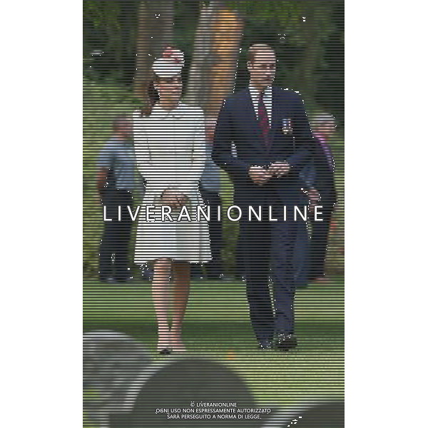 MONS, BELGIUM - AUGUST 04: Catherine, Duchess of Cambridge and Prince William, Duke of Cambridge walk through war graves at St Symphorien Military Cemetery on August 4, 2014 in Mons, Belgium. Monday 4th August marks the 100th Anniversary of Great Britain declaring war on Germany. In 1914 British Prime Minister Herbert Asquith announced at 11pm that Britain was to enter the war after Germany had violated Belgium\'s neutrality. The First World War or the Great War lasted until 11 November 1918 and is recognised as one of the deadliest historical conflicts with millions of casualties. A series of events commemorating the 100th Anniversary are taking place throughout the day. ©PHOTOSHOT/Agenzia Aldo Liverani sas - ITALY ONLY - EDITORIAL USE ONLY - REALI INGLESI: Il principe William d\'Inghilterra e la moglie Kate Duchessa di Cambridge e il principe Harry al St Symphorien cimitero militare a Mons, Belgio 4 agosto 2014 nel 100mo Anniversario della Grande guerra