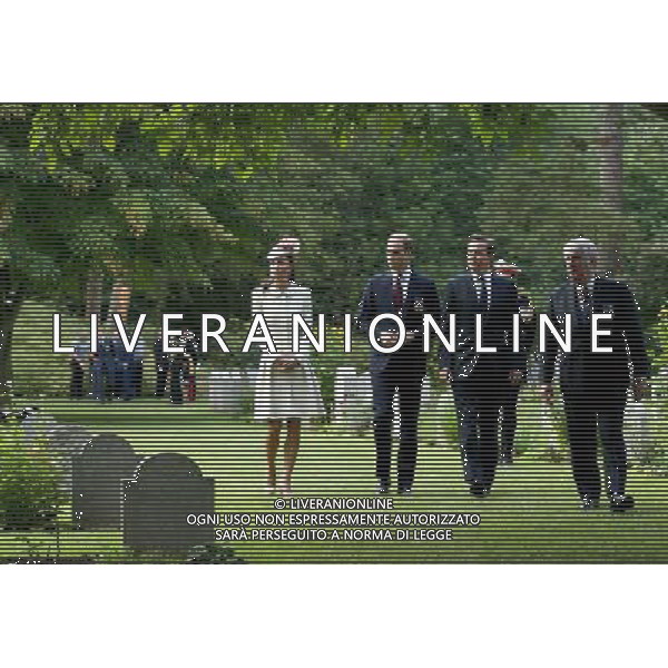 MONS, BELGIUM - AUGUST 04: Catherine, Duchess of Cambridge , Prince William, Duke of Cambridge and Prime Minister David Cameron walk through war graves at St Symphorien Military Cemetery on August 4, 2014 in Mons, Belgium. Monday 4th August marks the 100th Anniversary of Great Britain declaring war on Germany. In 1914 British Prime Minister Herbert Asquith announced at 11pm that Britain was to enter the war after Germany had violated Belgium\'s neutrality. The First World War or the Great War lasted until 11 November 1918 and is recognised as one of the deadliest historical conflicts with millions of casualties. A series of events commemorating the 100th Anniversary are taking place throughout the day. ©PHOTOSHOT/Agenzia Aldo Liverani sas - ITALY ONLY - EDITORIAL USE ONLY - REALI INGLESI: Il principe William d\'Inghilterra e la moglie Kate Duchessa di Cambridge e il principe Harry al St Symphorien cimitero militare a Mons, Belgio 4 agosto 2014 nel 100mo Anniversario della Grande guerra