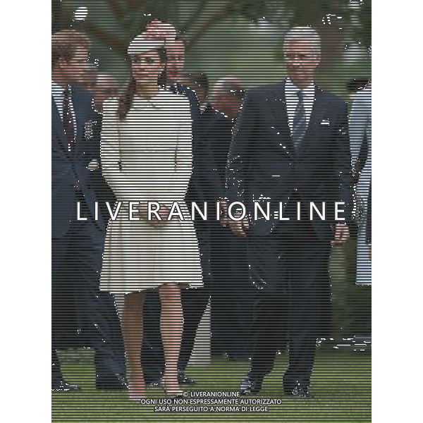 MONS, BELGIUM - AUGUST 04: Catherine, Duchess of Cambridge walks with King Philippe of Belgium past war graves at St Symphorien Military Cemetery on August 4, 2014 in Mons, Belgium. Monday 4th August marks the 100th Anniversary of Great Britain declaring war on Germany. In 1914 British Prime Minister Herbert Asquith announced at 11pm that Britain was to enter the war after Germany had violated Belgium\'s neutrality. The First World War or the Great War lasted until 11 November 1918 and is recognised as one of the deadliest historical conflicts with millions of casualties. A series of events commemorating the 100th Anniversary are taking place throughout the day. ©PHOTOSHOT/Agenzia Aldo Liverani sas - ITALY ONLY - EDITORIAL USE ONLY - REALI INGLESI: Il principe William d\'Inghilterra e la moglie Kate Duchessa di Cambridge e il principe Harry al St Symphorien cimitero militare a Mons, Belgio 4 agosto 2014 nel 100mo Anniversario della Grande guerra