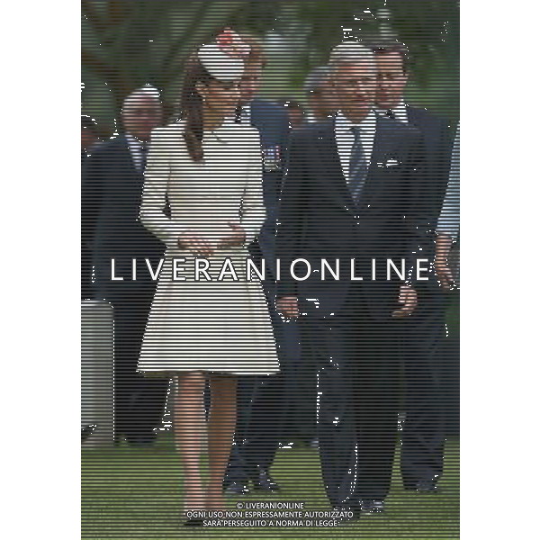 MONS, BELGIUM - AUGUST 04: Catherine, Duchess of Cambridge walks with King Philippe of Belgium past war graves at St Symphorien Military Cemetery on August 4, 2014 in Mons, Belgium. Monday 4th August marks the 100th Anniversary of Great Britain declaring war on Germany. In 1914 British Prime Minister Herbert Asquith announced at 11pm that Britain was to enter the war after Germany had violated Belgium\'s neutrality. The First World War or the Great War lasted until 11 November 1918 and is recognised as one of the deadliest historical conflicts with millions of casualties. A series of events commemorating the 100th Anniversary are taking place throughout the day. ©PHOTOSHOT/Agenzia Aldo Liverani sas - ITALY ONLY - EDITORIAL USE ONLY - REALI INGLESI: Il principe William d\'Inghilterra e la moglie Kate Duchessa di Cambridge e il principe Harry al St Symphorien cimitero militare a Mons, Belgio 4 agosto 2014 nel 100mo Anniversario della Grande guerra