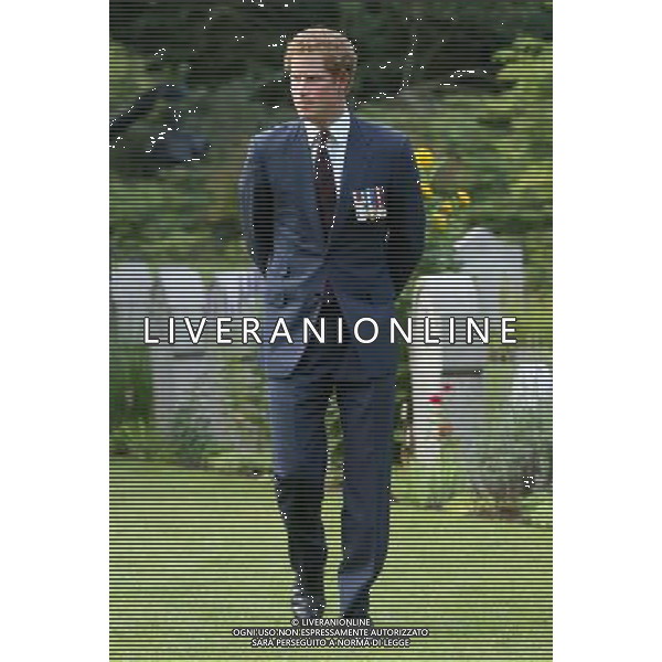 MONS, BELGIUM - AUGUST 04: Prince Harry looks at war graves at St Symphorien Military Cemetery on August 4, 2014 in Mons, Belgium. Monday 4th August marks the 100th Anniversary of Great Britain declaring war on Germany. In 1914 British Prime Minister Herbert Asquith announced at 11pm that Britain was to enter the war after Germany had violated Belgium\'s neutrality. The First World War or the Great War lasted until 11 November 1918 and is recognised as one of the deadliest historical conflicts with millions of casualties. A series of events commemorating the 100th Anniversary are taking place throughout the day. ©PHOTOSHOT/Agenzia Aldo Liverani sas - ITALY ONLY - EDITORIAL USE ONLY - REALI INGLESI: Il principe William d\'Inghilterra e la moglie Kate Duchessa di Cambridge e il principe Harry al St Symphorien cimitero militare a Mons, Belgio 4 agosto 2014 nel 100mo Anniversario della Grande guerra