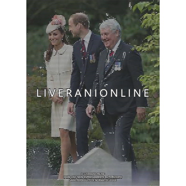 MONS, BELGIUM - AUGUST 04: Catherine, Duchess of Cambridge , Prince William, Duke of Cambridge and Vice Chairman of the Commonwealth War Graves Commission Sir Joe French walk through war graves at St Symphorien Military Cemetery on August 4, 2014 in Mons, Belgium. Monday 4th August marks the 100th Anniversary of Great Britain declaring war on Germany. In 1914 British Prime Minister Herbert Asquith announced at 11pm that Britain was to enter the war after Germany had violated Belgium\'s neutrality. The First World War or the Great War lasted until 11 November 1918 and is recognised as one of the deadliest historical conflicts with millions of casualties. A series of events commemorating the 100th Anniversary are taking place throughout the day. ©PHOTOSHOT/Agenzia Aldo Liverani sas - ITALY ONLY - EDITORIAL USE ONLY - REALI INGLESI: Il principe William d\'Inghilterra e la moglie Kate Duchessa di Cambridge e il principe Harry al St Symphorien cimitero militare a Mons, Belgio 4 agosto 2014 nel 100mo Anniversario della Grande guerra