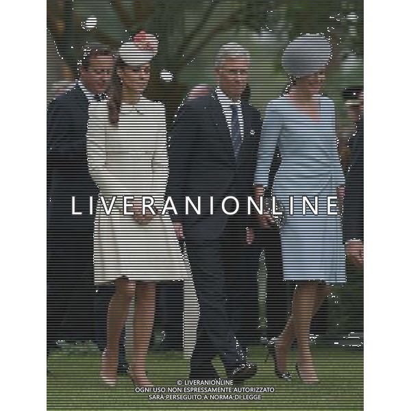 MONS, BELGIUM - AUGUST 04: Catherine, Duchess of Cambridge walks with King Philippe of Belgium and Queen Matilde of Belgium past war graves at St Symphorien Military Cemetery on August 4, 2014 in Mons, Belgium. Monday 4th August marks the 100th Anniversary of Great Britain declaring war on Germany. In 1914 British Prime Minister Herbert Asquith announced at 11pm that Britain was to enter the war after Germany had violated Belgium\'s neutrality. The First World War or the Great War lasted until 11 November 1918 and is recognised as one of the deadliest historical conflicts with millions of casualties. A series of events commemorating the 100th Anniversary are taking place throughout the day. ©PHOTOSHOT/Agenzia Aldo Liverani sas - ITALY ONLY - EDITORIAL USE ONLY - REALI INGLESI: Il principe William d\'Inghilterra e la moglie Kate Duchessa di Cambridge e il principe Harry al St Symphorien cimitero militare a Mons, Belgio 4 agosto 2014 nel 100mo Anniversario della Grande guerra