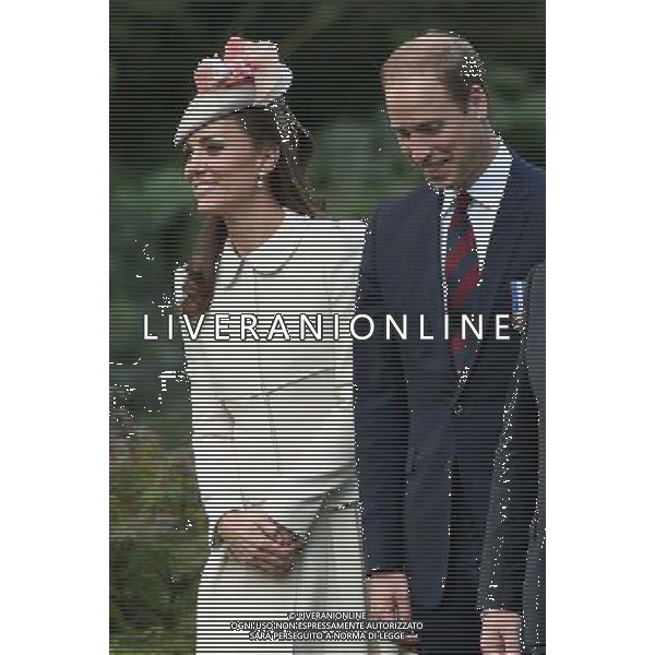 MONS, BELGIUM - AUGUST 04: Catherine, Duchess of Cambridge , Prince William, Duke of Cambridge and Vic Chairman of the Commonwealth War Graves Commission Sir Joe French walk through war graves at St Symphorien Military Cemetery on August 4, 2014 in Mons, Belgium. Monday 4th August marks the 100th Anniversary of Great Britain declaring war on Germany. In 1914 British Prime Minister Herbert Asquith announced at 11pm that Britain was to enter the war after Germany had violated Belgium\'s neutrality. The First World War or the Great War lasted until 11 November 1918 and is recognised as one of the deadliest historical conflicts with millions of casualties. A series of events commemorating the 100th Anniversary are taking place throughout the day. ©PHOTOSHOT/Agenzia Aldo Liverani sas - ITALY ONLY - EDITORIAL USE ONLY - REALI INGLESI: Il principe William d\'Inghilterra e la moglie Kate Duchessa di Cambridge e il principe Harry al St Symphorien cimitero militare a Mons, Belgio 4 agosto 2014 nel 100mo Anniversario della Grande guerra