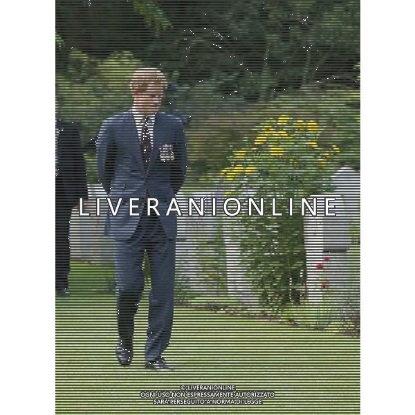MONS, BELGIUM - AUGUST 04: Prince Harry looks at war graves at St Symphorien Military Cemetery on August 4, 2014 in Mons, Belgium. Monday 4th August marks the 100th Anniversary of Great Britain declaring war on Germany. In 1914 British Prime Minister Herbert Asquith announced at 11pm that Britain was to enter the war after Germany had violated Belgium\'s neutrality. The First World War or the Great War lasted until 11 November 1918 and is recognised as one of the deadliest historical conflicts with millions of casualties. A series of events commemorating the 100th Anniversary are taking place throughout the day. ©PHOTOSHOT/Agenzia Aldo Liverani sas - ITALY ONLY - EDITORIAL USE ONLY - REALI INGLESI: Il principe William d\'Inghilterra e la moglie Kate Duchessa di Cambridge e il principe Harry al St Symphorien cimitero militare a Mons, Belgio 4 agosto 2014 nel 100mo Anniversario della Grande guerra
