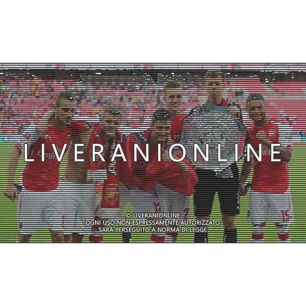 Arsenal\'s Mathieu Debuchy,Arsenal\'s Jack Wilshere,Arsenal\'s Olivier Giroud Arsenal\'s Calum Chambers, Arsenal\'s Wojciech Szcz?snyand Arsenal\'s Alex Oxlade-Chamberlain with the FA Community Shield Photographer Kieran Galvin/CameraSport Football Friendly - FA Community Shield - Arsenal v Manchester City - Sunday 10th August 2014 - Wembley - London © CameraSport - 43 Linden Ave. Countesthorpe. Leicester. England. LE8 5PG - Tel: +44 (0) 116 277 4147 - admin@camerasport.com - www.camerasport.com AG ALDO LIVERANI SAS ONLY ITALY