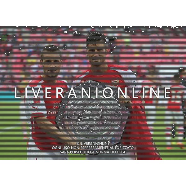 L-R Arsenal\'s Mathieu Debuchy and Arsenal\'s Olivier Giroud with the FA Community Shield Photographer Kieran Galvin/CameraSport Football Friendly - FA Community Shield - Arsenal v Manchester City - Sunday 10th August 2014 - Wembley - London © CameraSport - 43 Linden Ave. Countesthorpe. Leicester. England. LE8 5PG - Tel: +44 (0) 116 277 4147 - admin@camerasport.com - www.camerasport.com AG ALDO LIVERANI SAS ONLY ITALY