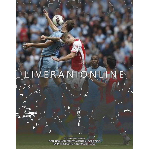 (140811) -- LONDON, Aug. 11, 2014 () -- Jack Wilshere(2nd, L) of Arsenal heads the ball with Edin Dzeko of Manchester City during the Community Shield match between Arsenal and Manchester City at Wembley Stadium in London, Britain on Aug. 10, 2014. Arsenal won 3-0. (/Wang Lili)(jyt) AG ALDO LIVERANI SAS ONLY ITALY