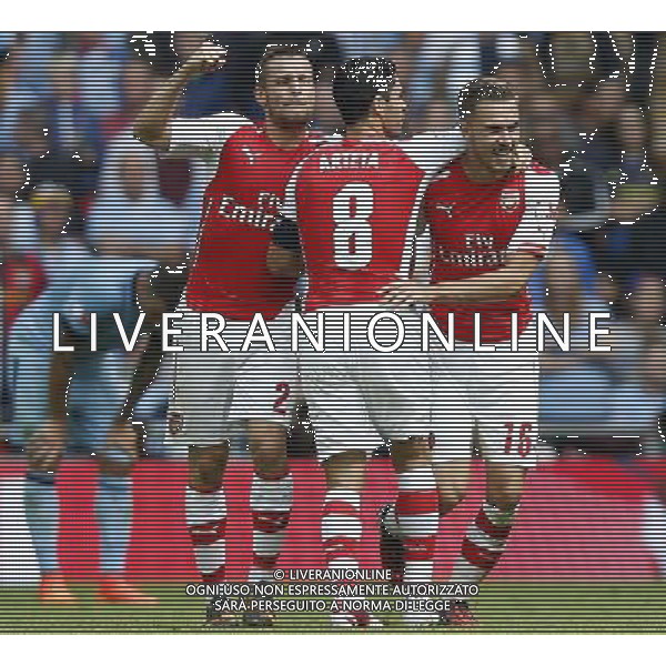 (140811) -- LONDON, Aug. 11, 2014 () -- Aaron Ramsey (1st, R)of Arsenal celebrates scoring with teammates Mathieu Debuchy(2nd, L) and Mikel Arteta(2nd, R) during the Community Shield match between Arsenal and Manchester City at Wembley Stadium in London, Britain on Aug. 10, 2014. Arsenal won 3-0. (/Wang Lili)(by) AG ALDO LIVERANI SAS ONLY ITALY