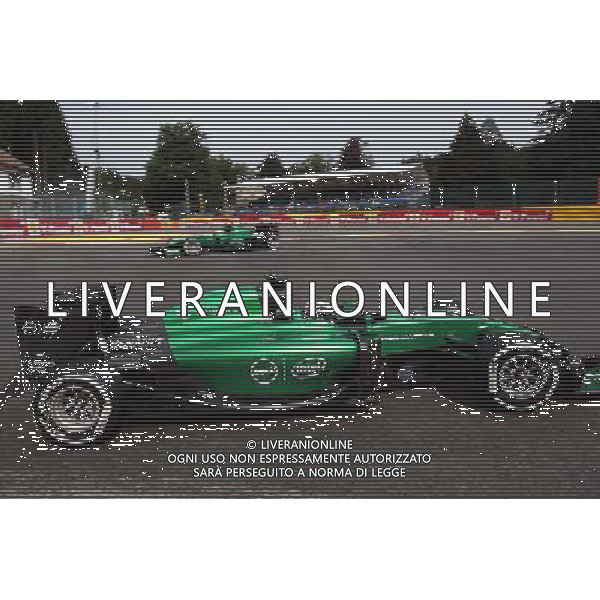 Marcus Ericsson (SWE) Caterham CT05 spins at La Source in FP1 and is passed by team mate Andre Lotterer (GER) Caterham CT05. 22.08.2014. Formula 1 World Championship, Rd 12, Belgian Grand Prix, Spa Francorchamps, Belgium, Practice Day. AG ALDO LIVERANI SAS ONLY ITALY