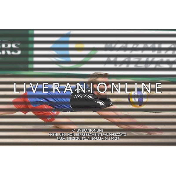 21.08.2014 - Stare Jablonki , siatkowka plazowa , beach volleyball , World Tour , FIVB Stare Jablonki Grand Slam 2014 , Polska (zielone) - Rosja (niebieskie) , Poland - Russia N/Z Dmitri Barsouk Fot. Mariusz Palczynski / MPAimages.com/NEWSPIX.PL --- Newspix.pl /Agenzia Aldo Liverani sas - ITALY ONLY - Polonia - Russia beach volley maschile, World Tour, FIVB Stare Jablonki Grande Slam 2014 *** Local Caption *** www.newspix.pl mail us: info@newspix.pl call us: 0048 022 23 22 222 --- Polish Picture Agency by Ringier Axel Springer Poland