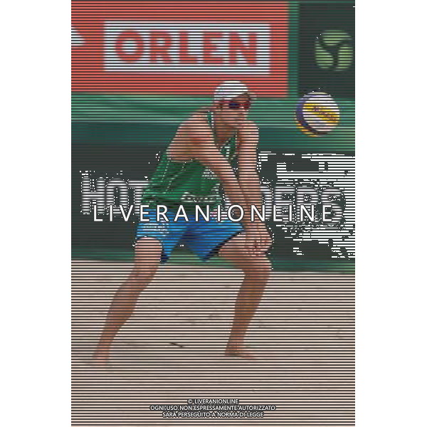 22.08.2014 - Stare Jablonki , siatkowka plazowa , beach volleyball , World Tour , FIVB Stare Jablonki Grand Slam 2014 , Polska (zielone) - Brazilia (czerwone) , Poland - Brazil N/Z Mariusz Prudel Fot. Mariusz Palczynski / MPAimages.com/NEWSPIX.PL --- Newspix.pl /Agenzia Aldo Liverani sas - ITALY ONLY - Polonia - Brasile beach volley maschile, World Tour, FIVB Stare Jablonki Grande Slam 2014 *** Local Caption *** www.newspix.pl mail us: info@newspix.pl call us: 0048 022 23 22 222 --- Polish Picture Agency by Ringier Axel Springer Poland