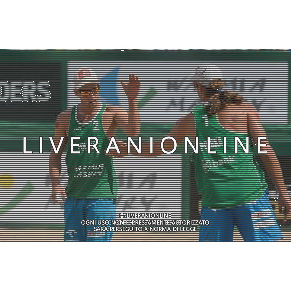 22.08.2014 - Stare Jablonki , siatkowka plazowa , beach volleyball , World Tour , FIVB Stare Jablonki Grand Slam 2014 , Polska (zielone) - Brazilia (czerwone) , Poland - Brazil N/Z Grzegorz Fijalek , Mariusz Prudel Fot. Mariusz Palczynski / MPAimages.com/NEWSPIX.PL --- Newspix.pl /Agenzia Aldo Liverani sas - ITALY ONLY - Polonia - Brasile beach volley maschile, World Tour, FIVB Stare Jablonki Grande Slam 2014 *** Local Caption *** www.newspix.pl mail us: info@newspix.pl call us: 0048 022 23 22 222 --- Polish Picture Agency by Ringier Axel Springer Poland