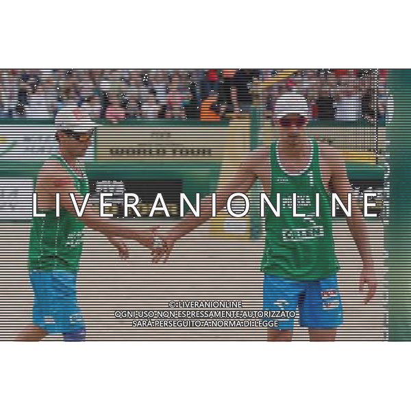 22.08.2014 - Stare Jablonki , siatkowka plazowa , beach volleyball , World Tour , FIVB Stare Jablonki Grand Slam 2014 , Polska (zielone) - Brazilia (czerwone) , Poland - Brazil N/Z Grzegorz Fijalek , Mariusz Prudel Fot. Mariusz Palczynski / MPAimages.com/NEWSPIX.PL --- Newspix.pl /Agenzia Aldo Liverani sas - ITALY ONLY - Polonia - Brasile beach volley maschile, World Tour, FIVB Stare Jablonki Grande Slam 2014 *** Local Caption *** www.newspix.pl mail us: info@newspix.pl call us: 0048 022 23 22 222 --- Polish Picture Agency by Ringier Axel Springer Poland