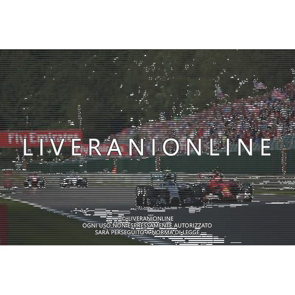 Nico Rosberg (GER) Mercedes AMG F1 W05 and Kimi Raikkonen (FIN) Ferrari F14-T battle for position. 24.08.2014. Formula 1 World Championship, Rd 12, Belgian Grand Prix, Spa Francorchamps, Belgium, Race Day. AG ALDO LIVERANI SAS ONLY ITALY