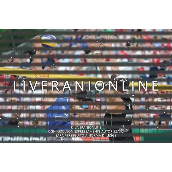 24.08.2014 - Stare Jablonki , siatkowka plazowa , beach volleyball , World Tour , FIVB Stare Jablonki Grand Slam 2014 , USA (niebieskie) - Austria (czarne) , USA (blue) - Austria (black) N/Z Casey Patterson , Clemens Doppler Fot. Karol Bartnik / MPAimages.com/NEWSPIX.PL --- Newspix.pl /Agenzia Aldo Liverani sas - ITALY ONLY - EDITORIAL USE ONLY - BEACHVOLLEY *** Local Caption *** www.newspix.pl mail us: info@newspix.pl call us: 0048 022 23 22 222 --- Polish Picture Agency by Ringier Axel Springer Poland