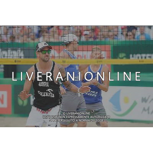 24.08.2014 - Stare Jablonki , siatkowka plazowa , beach volleyball , World Tour , FIVB Stare Jablonki Grand Slam 2014 , USA (niebieskie) - Austria (czarne) , USA (blue) - Austria (black) N/Z Clemens Doppler Fot. Karol Bartnik / MPAimages.com/NEWSPIX.PL --- Newspix.pl /Agenzia Aldo Liverani sas - ITALY ONLY - EDITORIAL USE ONLY - BEACHVOLLEY *** Local Caption *** www.newspix.pl mail us: info@newspix.pl call us: 0048 022 23 22 222 --- Polish Picture Agency by Ringier Axel Springer Poland